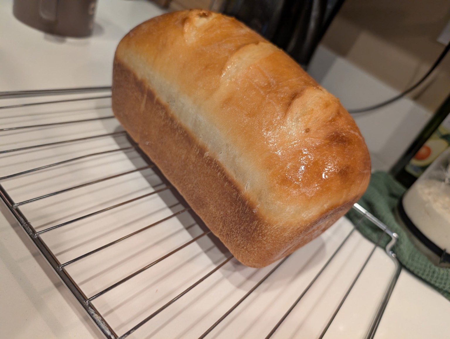 Baker holding fresh cinnamon rolls and bread