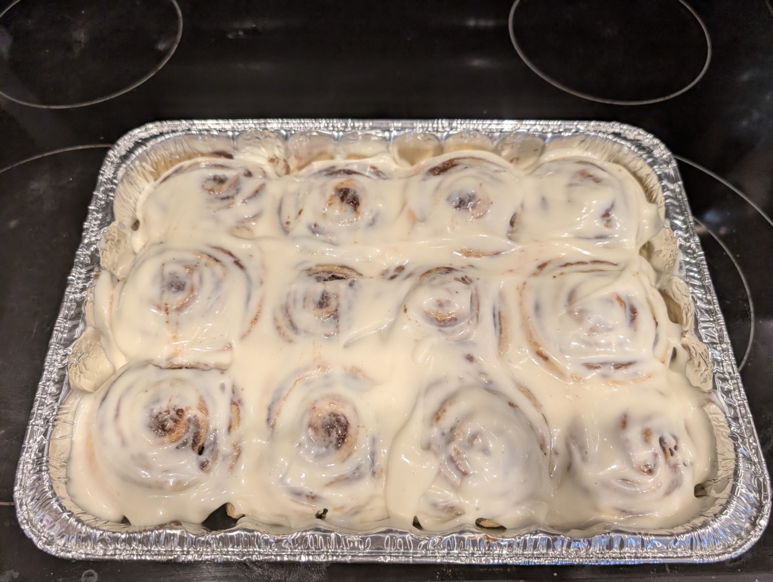 Frosted cinnamon rolls in pan