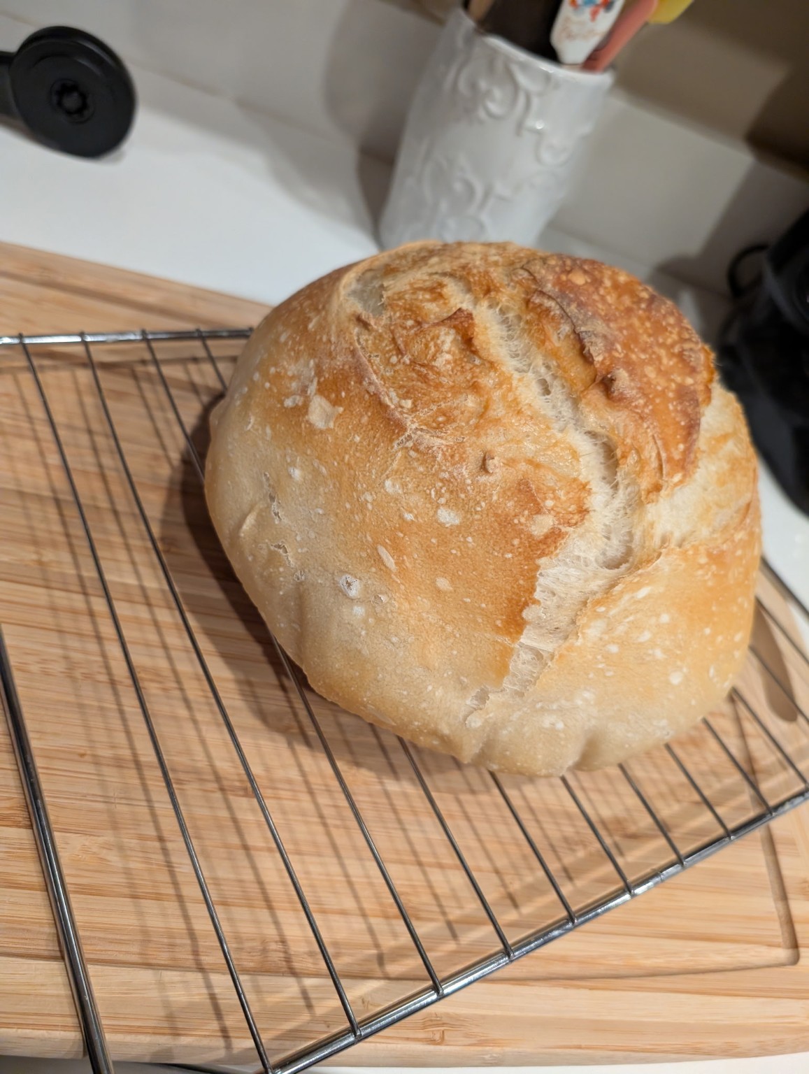 Traditional sourdough boule on cooling rack