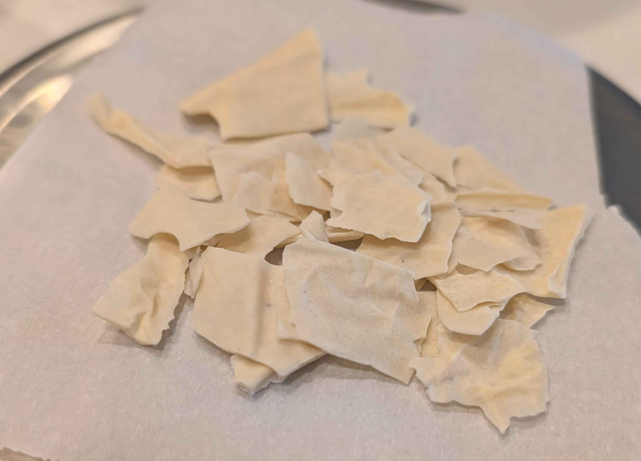 Dehydrated sourdough starter flakes on parchment